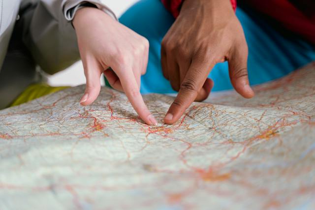 people using their fingers to point at a map