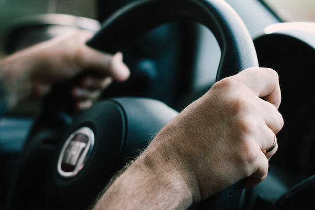person-holding-a-steering-wheel